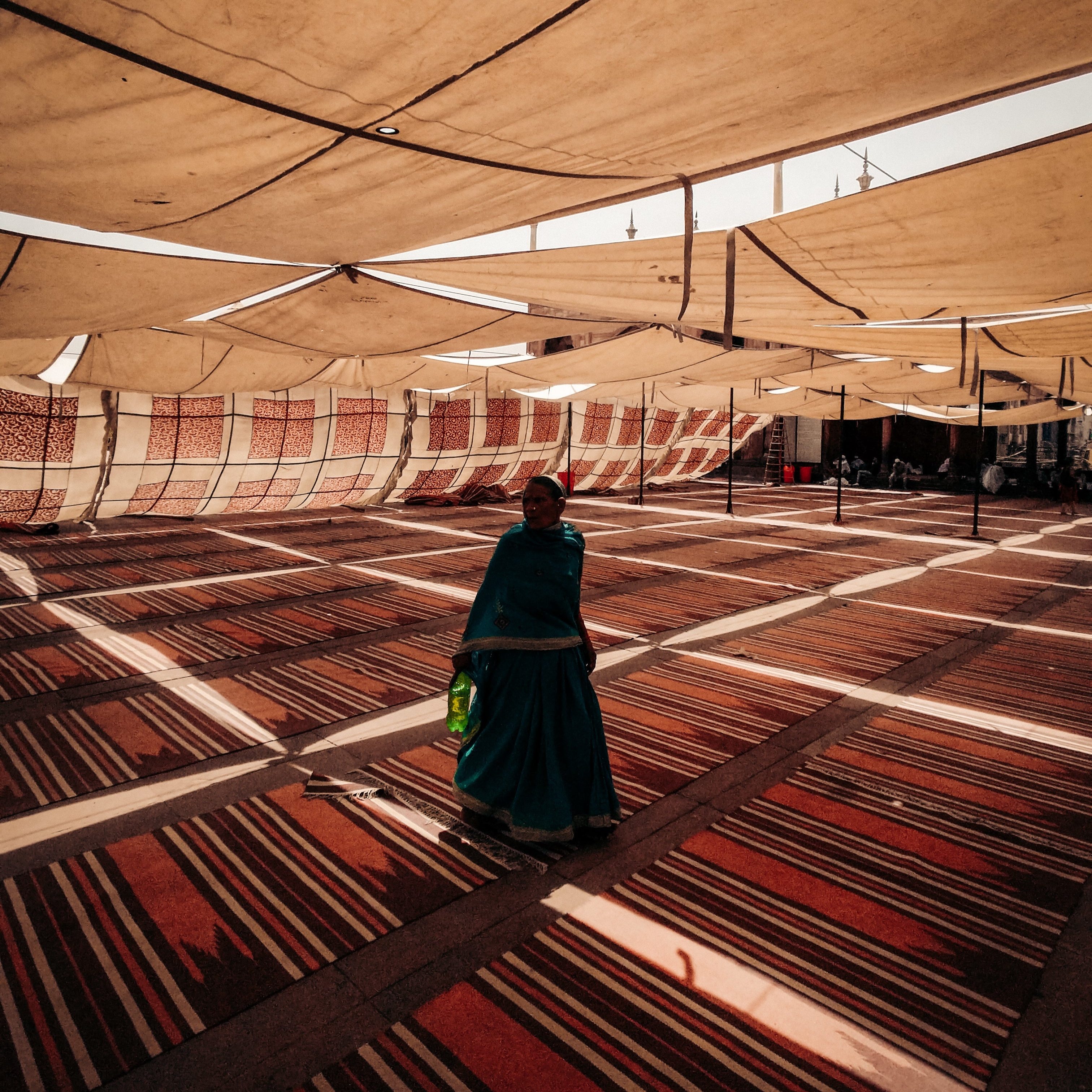 a woman standing on handmade traditional rugs